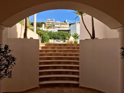 a set of stairs in a building with an archway at Lovely Burgau villa just 3 mins walk from beach in Budens