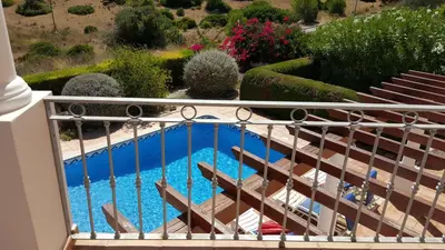 a view of a pool from a balcony at Lovely Burgau villa just 3 mins walk from beach in Budens
