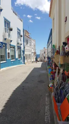 a street in a town with blue and white buildings at Lovely Burgau villa just 3 mins walk from beach in Budens
