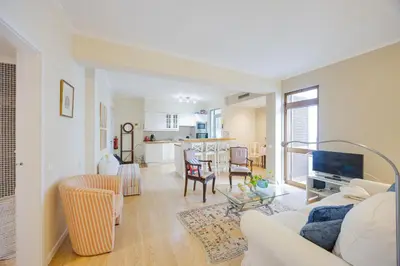 a living room with a couch and a table at Central Funchal Apartment - GARDEN - Free Parking & AC in Funchal