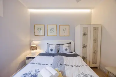 a bedroom with a bed with two pillows at Central Funchal Apartment - GARDEN - Free Parking & AC in Funchal