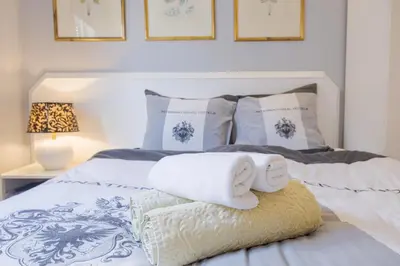 a bedroom with a bed with towels on it at Central Funchal Apartment - GARDEN - Free Parking & AC in Funchal