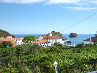 a view of a town with the ocean in the background at Villa Matilde e Joaquim in Porto da Cruz