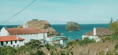 a walkway next to a fence next to the water at Villa Matilde e Joaquim in Porto da Cruz