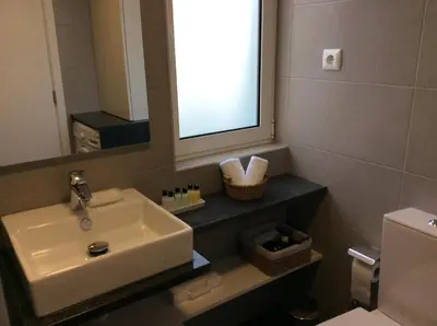 a bathroom with a sink and a mirror and a toilet at CHARMING LIDO FLAT II in Funchal
