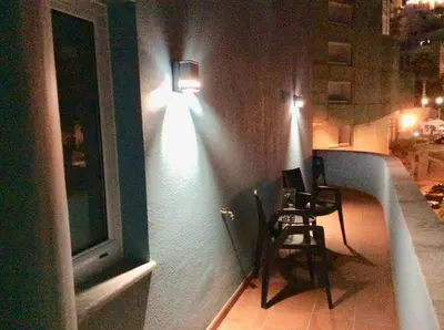 a room with a chair and a window at night at CHARMING LIDO FLAT II in Funchal