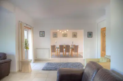 a living room with a couch and a table at Villa Montanha, 4 Bedroom Villa, with swimming pool, loungers and alfresco dining, 10 min walk to the beautiful Praia da Luz Beach, Shops, Bars and Restaurants! in Luz