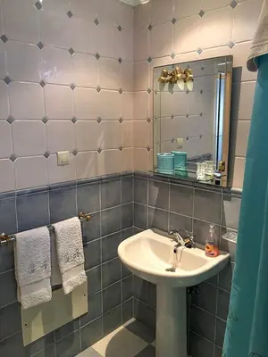 a bathroom with a sink and a mirror at Casa Charmosa in Funchal