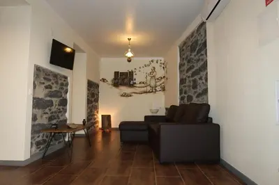 a living room with a couch and a table at Vila Maria Quinta 13 