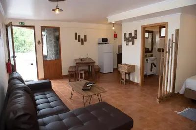 a living room with a couch and a table at Vila Maria Quinta 13 