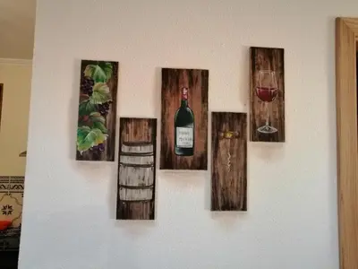 a wall with four pictures of wine bottles and a glass at Vila Maria Quinta 13 