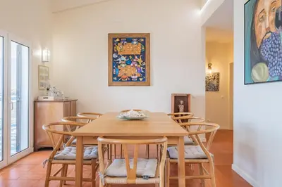 a dining room with a wooden table and chairs at Beach House - By WeHost in Santa Cruz