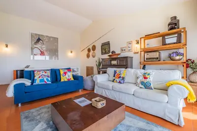 a living room with two couches and a coffee table at Beach House - By WeHost in Santa Cruz