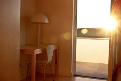 a room with a desk and a lamp and a window at Azores Youth Hostels - Santa Maria in Vila do Porto