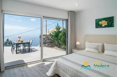 a bathroom with a sink and a toilet and a shower at OurMadeira - CalhetaScape in Calheta