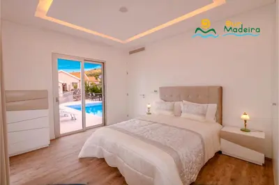 a villa with a swimming pool and a house at OurMadeira - CalhetaScape in Calheta