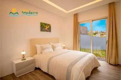 a living room with a table and chairs and a pool at OurMadeira - CalhetaScape in Calheta