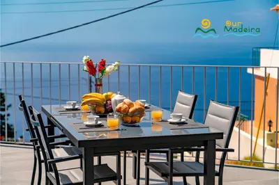 a bedroom with a bed and a large window at OurMadeira - CalhetaScape in Calheta