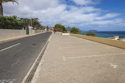 an empty street with the ocean in the background at Pedra do Jota in Porto Santo
