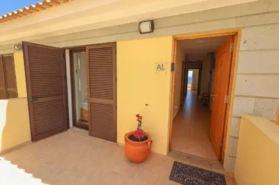 a balcony of a house with a plant in a pot at Pedra do Jota in Porto Santo