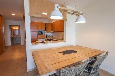 a kitchen and dining room with a wooden table at Pedra do Jota in Porto Santo