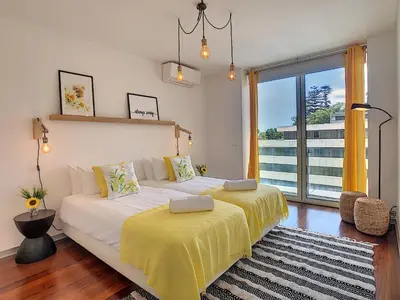 a bedroom with two beds and a large window at Apartment Sunniva by LovelyStay in Funchal