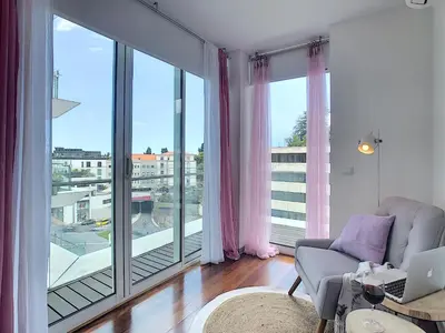 a living room with a couch and a large window at Apartment Sunniva by LovelyStay in Funchal