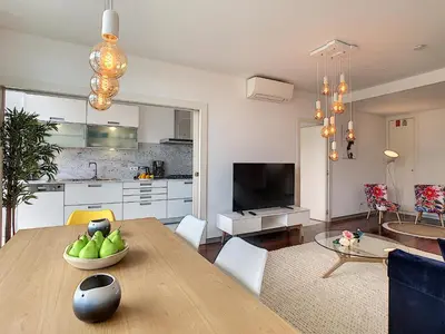 a kitchen and living room with a wooden table and chairs at Apartment Sunniva by LovelyStay in Funchal