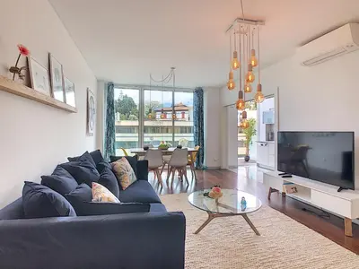 a living room with a blue couch and a tv at Apartment Sunniva by LovelyStay in Funchal