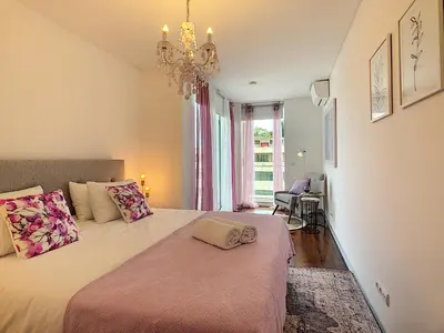 a bedroom with a large bed with a chandelier at Apartment Sunniva by LovelyStay in Funchal