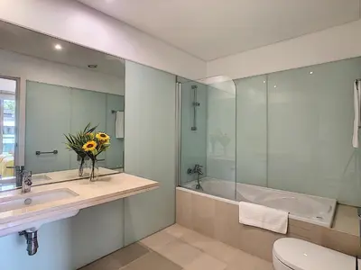 a bathroom with a sink and a tub and a toilet at Apartment Sunniva by LovelyStay in Funchal