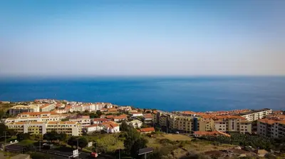 a city with buildings and the ocean in the background at Savana Apartment By Atlantic Holiday in Nogueira