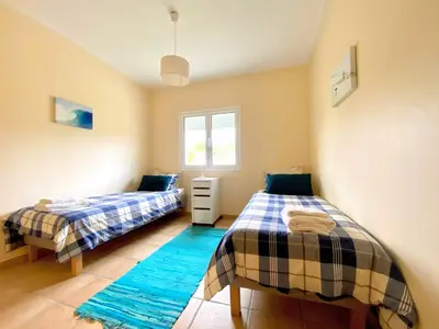 a bedroom with two beds and a window at Varandas - Arrifana, com piscina, junto à praia in Praia da Arrifana