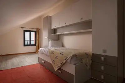 a bedroom with a bed and a book shelf at SEA VIEW LOFT MADEIRA in Ribeira Brava