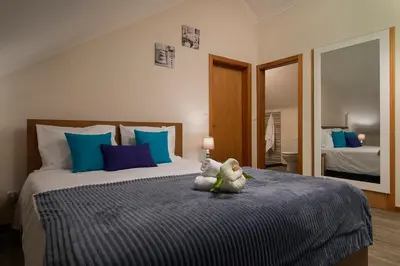 a bedroom with a bed with a stuffed animal on it at SEA VIEW LOFT MADEIRA in Ribeira Brava