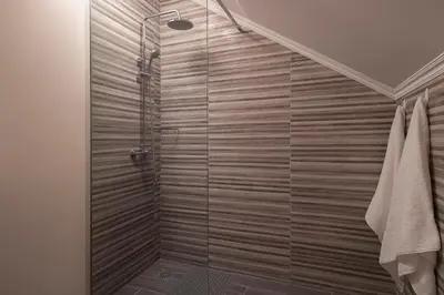 a bathroom with a shower with a glass door at SEA VIEW LOFT MADEIRA in Ribeira Brava