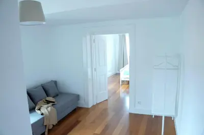 a living room with a blue couch and a mirror at Heritage Apartments in Funchal