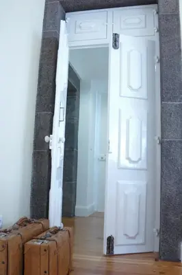 a room with two suitcases in front of a door at Heritage Apartments in Funchal