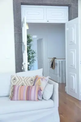a white couch with pillows on it in a living room at Heritage Apartments in Funchal