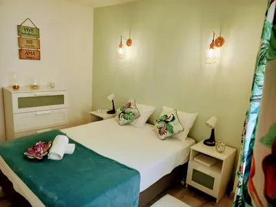 a small bedroom with a white bed with two pillows at Casa O Recanto in Raposeira