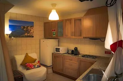 a small kitchen with a refrigerator and a microwave at Casa O Recanto in Raposeira
