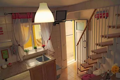 a small kitchen with a sink and a window at Casa O Recanto in Raposeira