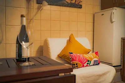 a living room with a couch and a table with a wine glass at Casa O Recanto in Raposeira