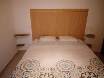 a bedroom with a bed with a white bedspread at O Nosso Lar in Lagos