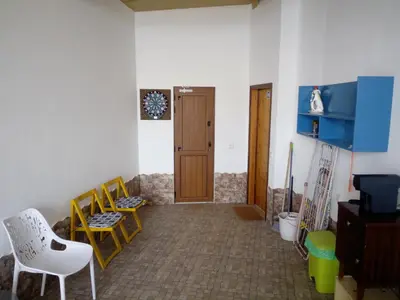 a room with chairs and a door and a table at O Nosso Lar in Lagos