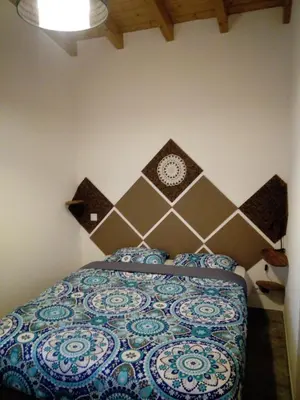 a bedroom with a bed with a clock on the wall at O Nosso Lar in Lagos