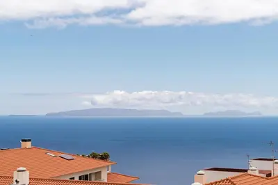 a view of the ocean from the roofs of houses at Garajau II by An Island Apart in Caniço