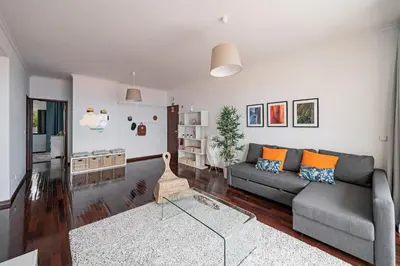 a living room with a couch and a table at Garajau II by An Island Apart in Caniço