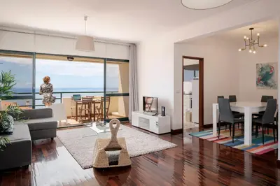 a living room with a couch and a table at Garajau II by An Island Apart in Caniço