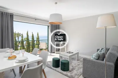 a living room with a white table and chairs at Promenade I by An Island Apart in Funchal